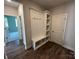 Mudroom with bench, hooks, shelves, and wood-look flooring at 2017 Embassy Ct # 51, Charlotte, NC 28213