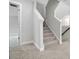 Bright, carpeted staircase with white trim leads to the upper level, showcasing modern design and accessibility at 2017 Embassy Ct # 51, Charlotte, NC 28213