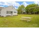 View of the backyard and home featuring a well-manicured lawn and mature trees at 203 Ackert Ave, Salisbury, NC 28144