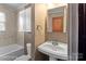 Bathroom featuring vanity, toilet, and tiled tub with shower at 203 Ackert Ave, Salisbury, NC 28144