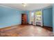 A spacious bedroom with blue walls, hardwood floors, and natural light streaming in from the windows at 203 Ackert Ave, Salisbury, NC 28144