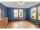 Comfortable bedroom with hardwood floors, two windows, and a classic dresser at 203 Ackert Ave, Salisbury, NC 28144