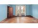 Sunlit bedroom featuring hardwood floors and blue walls at 203 Ackert Ave, Salisbury, NC 28144