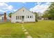 Side view of a single-story home featuring a well-manicured lawn and classic shutters at 203 Ackert Ave, Salisbury, NC 28144