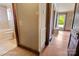 Hallway and bathroom view features tile flooring, wainscotting, and a doorway to the outside at 203 Ackert Ave, Salisbury, NC 28144