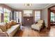 Inviting living room with brick fireplace, hardwood floors, and comfortable seating arrangement at 203 Ackert Ave, Salisbury, NC 28144