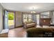 Relaxing living room with hardwood floors, a brick fireplace, and ample natural light at 203 Ackert Ave, Salisbury, NC 28144