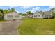 View of the detached two-car garage and home surrounded by expansive lawn at 203 Ackert Ave, Salisbury, NC 28144