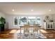 Bright dining room with lake views, wood floors, and stylish furnishings at 2066 Marquesas Ave, Fort Mill, SC 29708