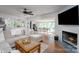 Bright open-concept living room featuring a fireplace, hardwood floors, and an adjacent dining area at 2066 Marquesas Ave, Fort Mill, SC 29708