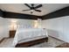 Beautiful bedroom with white wainscoting, a ceiling fan, and a comfy bed at 2066 Marquesas Ave, Fort Mill, SC 29708