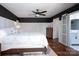 Main bedroom featuring an ensuite bathroom, wainscoting, ceiling fan and hardwood floors at 2066 Marquesas Ave, Fort Mill, SC 29708