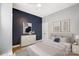 Cozy bedroom with a navy accent wall and modern decor at 2094 Euclid Ave, Charlotte, NC 28203