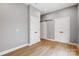 This bedroom features neutral walls, hardwood floors, and multiple closets for ample storage solutions at 2094 Euclid Ave, Charlotte, NC 28203