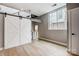 This bedroom features sliding barn doors, hardwood floors, and a bright window with views of the neighborhood at 2094 Euclid Ave, Charlotte, NC 28203