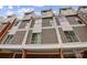 Townhome complex with modern exterior design, showcasing clean lines and balcony features under a partly cloudy sky at 2094 Euclid Ave, Charlotte, NC 28203