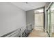 This hallway has modern railings, hardwood floors, and offers neighborhood views from a large window at 2094 Euclid Ave, Charlotte, NC 28203