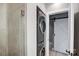 This laundry area is tiled and features a stackable washer and dryer, and barn door to another room at 2094 Euclid Ave, Charlotte, NC 28203
