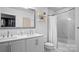 Clean bathroom featuring double sinks, white cabinets, and a shower-tub combination at 210 N Church St # 3507, Charlotte, NC 28202