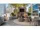 Outdoor patio featuring a stone fireplace, grill, and comfortable seating at 210 N Church St # 3507, Charlotte, NC 28202