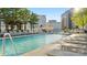 Rooftop pool with lounge chairs and city views at 210 N Church St # 3507, Charlotte, NC 28202