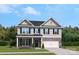 Charming two-story home with stone accents, black shutters, manicured lawn, and attached two car garage at 216 Coronado Ave, Matthews, NC 28104