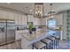 Modern kitchen with large island, stainless steel appliances, granite countertops, and pendant lighting at 216 Coronado Ave, Matthews, NC 28104