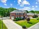 Aerial view of a traditional brick home with well-manicured lawn, mature trees, and a private driveway at 2808 Park Ridge Blvd, Rock Hill, SC 29732