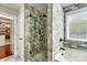 Modern bathroom with glass shower, stone tile, soaking tub, decorative tile flooring and walk-in closet at 2808 Park Ridge Blvd, Rock Hill, SC 29732