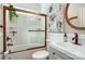 Elegant bathroom featuring a tub, shower, modern sink, stylish vanity and neutral decor with white floral artwork at 2808 Park Ridge Blvd, Rock Hill, SC 29732