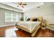 Bright bedroom with hardwood floors, white walls, a ceiling fan and a bed with throw pillows at 2808 Park Ridge Blvd, Rock Hill, SC 29732