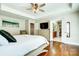 Bright primary bedroom with wood floors, bed, dresser, ceiling fan and an ensuite bathroom and closet at 2808 Park Ridge Blvd, Rock Hill, SC 29732