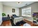 Modern bedroom with a cozy bed, dark accents, and natural light from a large window at 2808 Park Ridge Blvd, Rock Hill, SC 29732