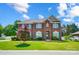 Charming brick home featuring blue shutters, lush landscaping, and a well-manicured lawn at 2808 Park Ridge Blvd, Rock Hill, SC 29732