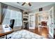 Bright office featuring hardwood floors, shelving, a ceiling fan, large windows, and a view to the dining room at 2808 Park Ridge Blvd, Rock Hill, SC 29732