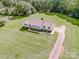 Aerial view of the home showcasing expansive lawn and mature trees at 2811 Saint James Church Rd, Denver, NC 28037