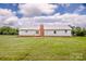 Expansive backyard with large brick chimney and rear view of single story home at 2811 Saint James Church Rd, Denver, NC 28037