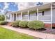 Inviting front porch with brick steps, black mulch beds, and shrubs leading to the front door at 2811 Saint James Church Rd, Denver, NC 28037