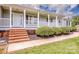 Inviting front porch with brick steps, black mulch beds, and shrubs leading to the front door at 2811 Saint James Church Rd, Denver, NC 28037