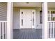 Inviting front porch with grey wood flooring and bright white trim at 2811 Saint James Church Rd, Denver, NC 28037