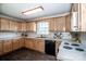 Well-lit kitchen featuring wood cabinets, laminate countertops and modern appliances at 2811 Saint James Church Rd, Denver, NC 28037