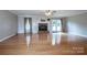 Bright living room featuring hardwood floors and brick fireplace at 2811 Saint James Church Rd, Denver, NC 28037