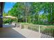 Large wooden deck featuring patio umbrella and view of lush backyard at 3103 Lauren Glen Rd, Charlotte, NC 28226