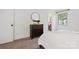 Cozy bedroom featuring a charming dresser and view into en-suite bath at 3103 Lauren Glen Rd, Charlotte, NC 28226