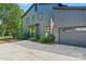 Modern home exterior with attached garage, sleek design, and an American flag, showcasing curb appeal at 3103 Lauren Glen Rd, Charlotte, NC 28226