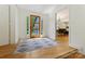 Bright foyer with wood floors, stylish rug, and views into the open concept living spaces at 3103 Lauren Glen Rd, Charlotte, NC 28226