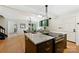 Open kitchen with a marble island, modern range, and stylish lighting at 3103 Lauren Glen Rd, Charlotte, NC 28226