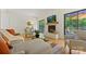 Bright living space featuring a fireplace, hardwood floors, and sliding glass doors to the deck at 3103 Lauren Glen Rd, Charlotte, NC 28226