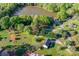 Beautiful aerial view of property and lake, showing lush greenery, garden, and outdoor shed at 311 Cooks Lake Rd, Gastonia, NC 28056