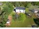 Aerial view of the property showcasing its expansive yard, white home, and surrounding greenery at 311 Cooks Lake Rd, Gastonia, NC 28056